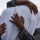John Thompson, a friend and former colleague of Philando Castile’s, is embraced after speaking on the steps of the Minnesota Capitol on June 16, 2017, in St. Paul, Minn., after a police officer, Jeronimo Yanez, was acquitted on all counts in Castile’s shooting death. (Stephen Maturen/Getty Images)